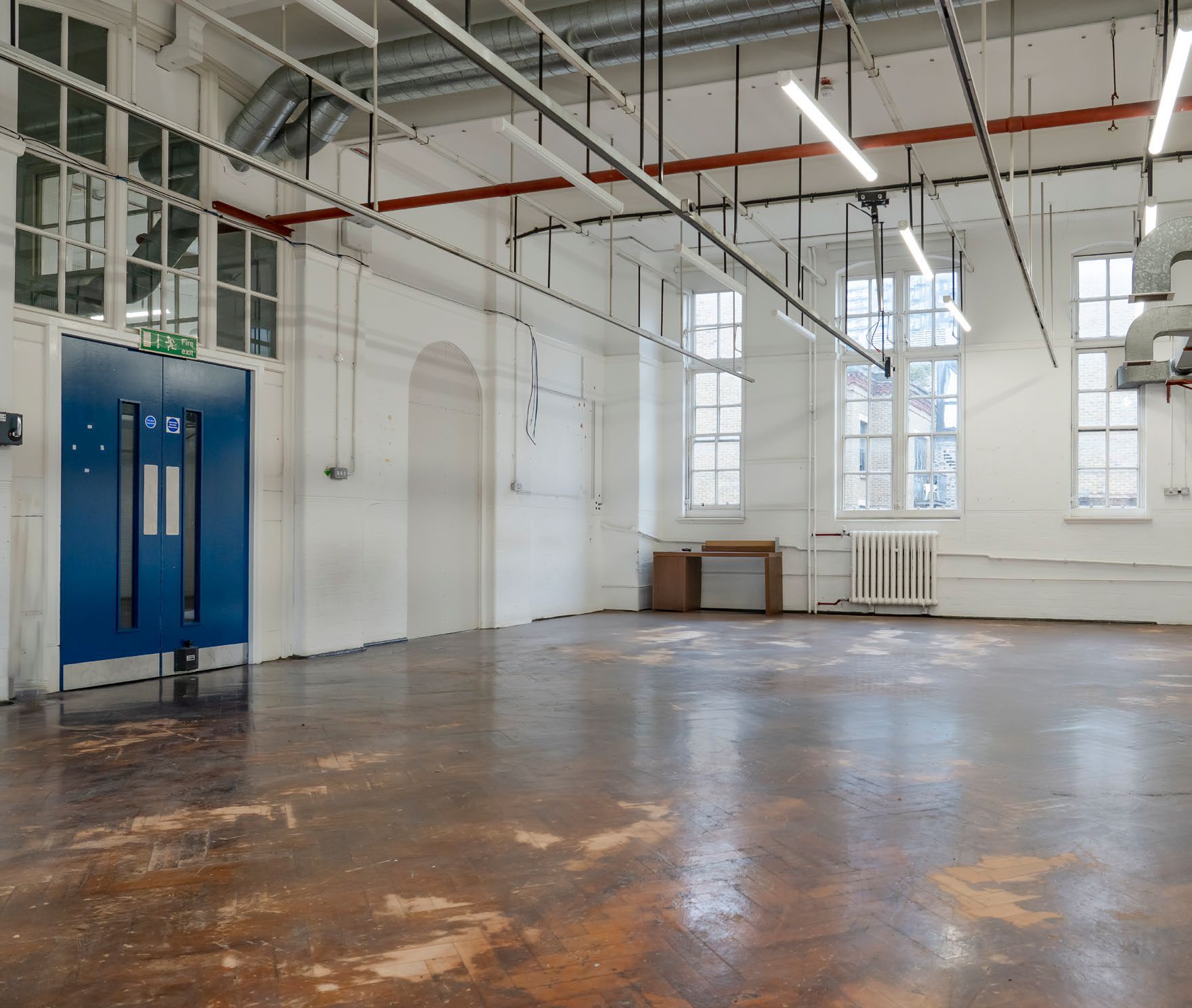 Former teaching space with tall arched windows