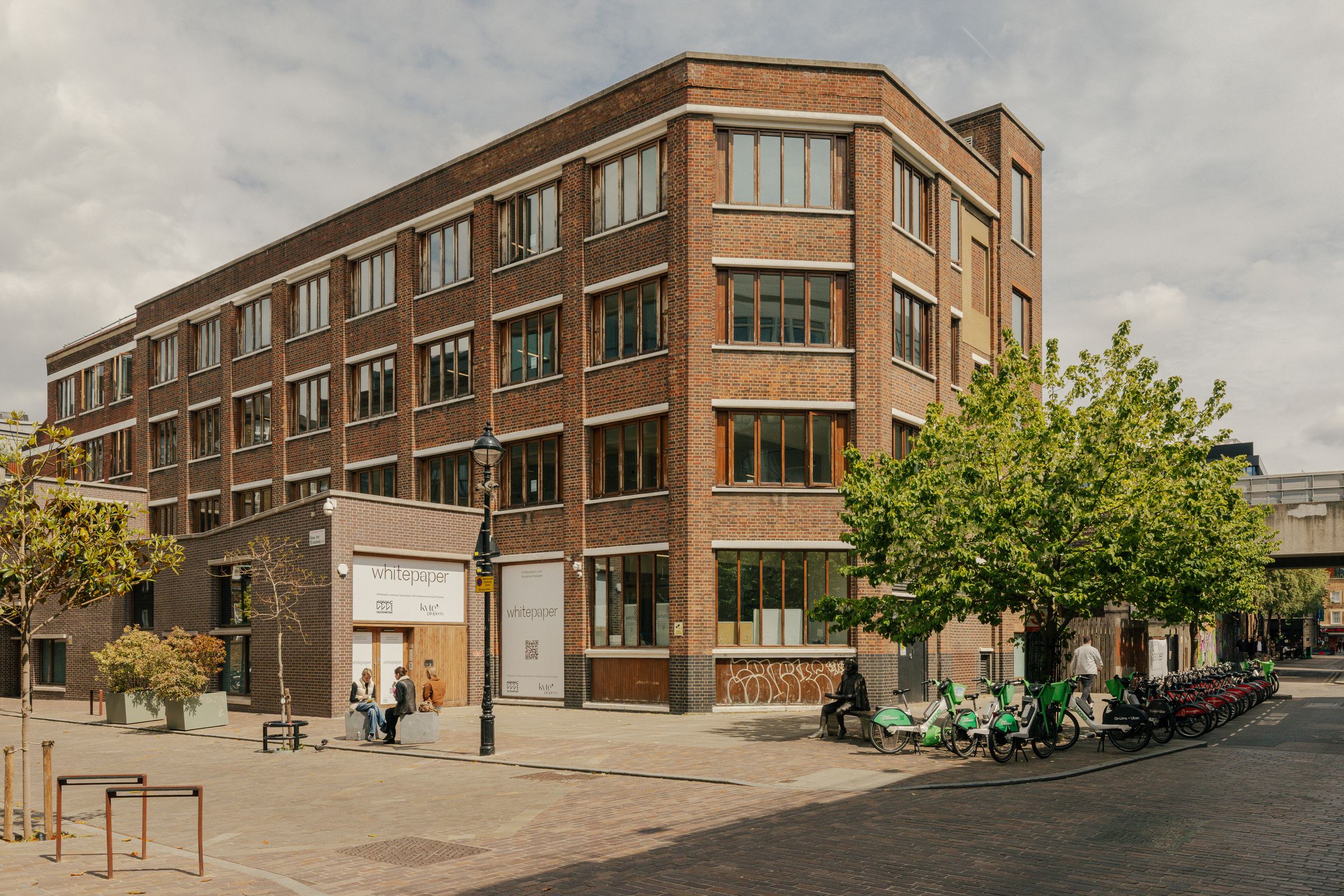 17–25 New Inn Yard, a four-storey brick building on a Shoreditch street corner